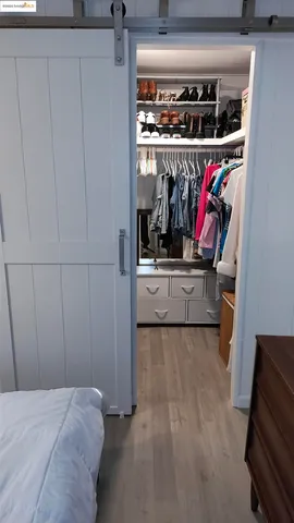 a bedroom with a bed and a mirror