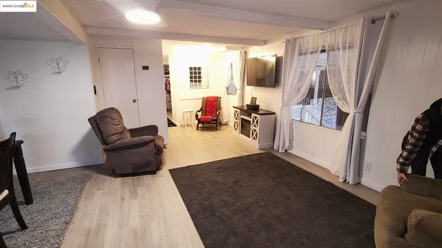 a living room with furniture and a mirror