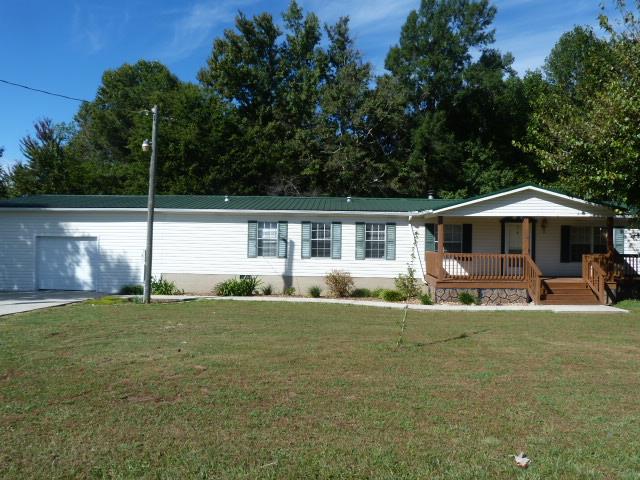 4829 Asbury Road Manchester, TN 37355 - Photo 1 of 29 a front view of a house with a yard