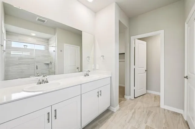 a spacious bathroom with a double vanity sink mirror and