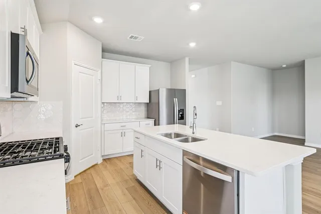 a kitchen with a sink a stove and refrigerator