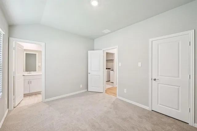 a view of an empty room and closet area