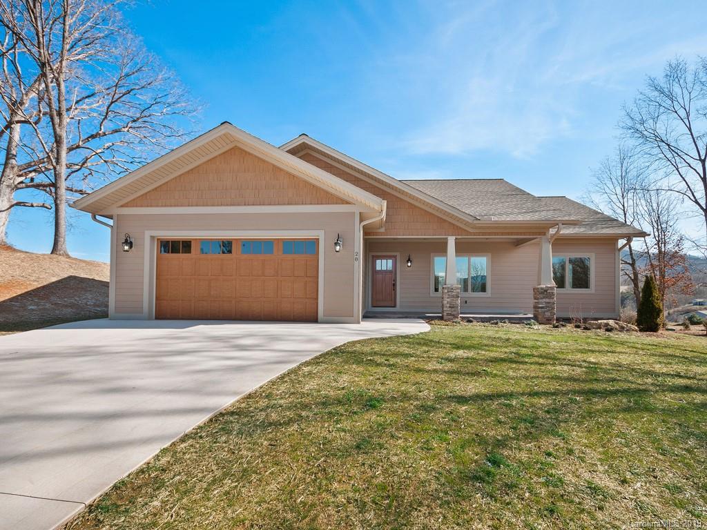 28 Jasper Ridge Clyde, NC 28721 - Photo 2 of 24 a front view of a house with a garden and yard