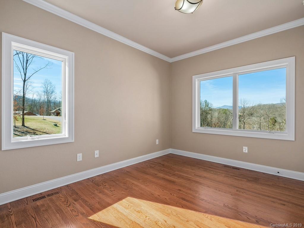 28 Jasper Ridge Clyde, NC 28721 - Photo 11 of 24 a view of an empty room with wooden floor and a window