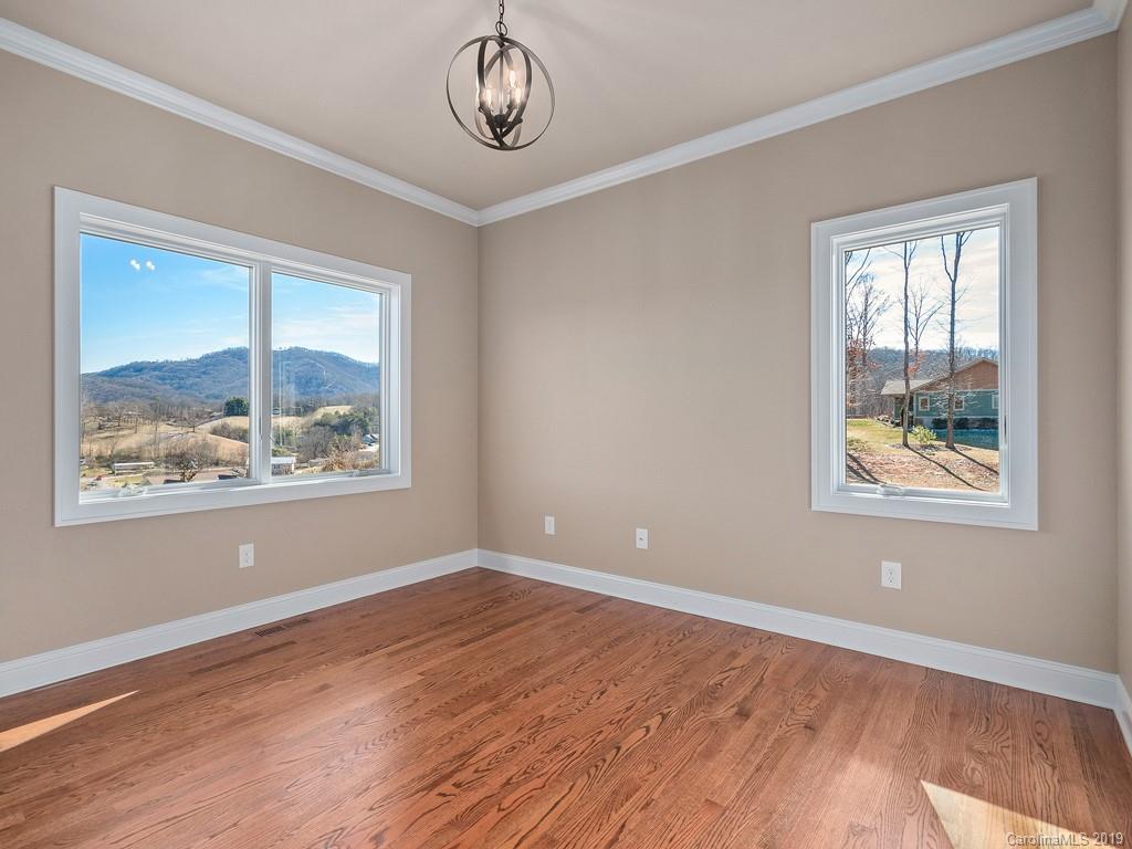 28 Jasper Ridge Clyde, NC 28721 - Photo 13 of 24 a view of an empty room with wooden floor and a window