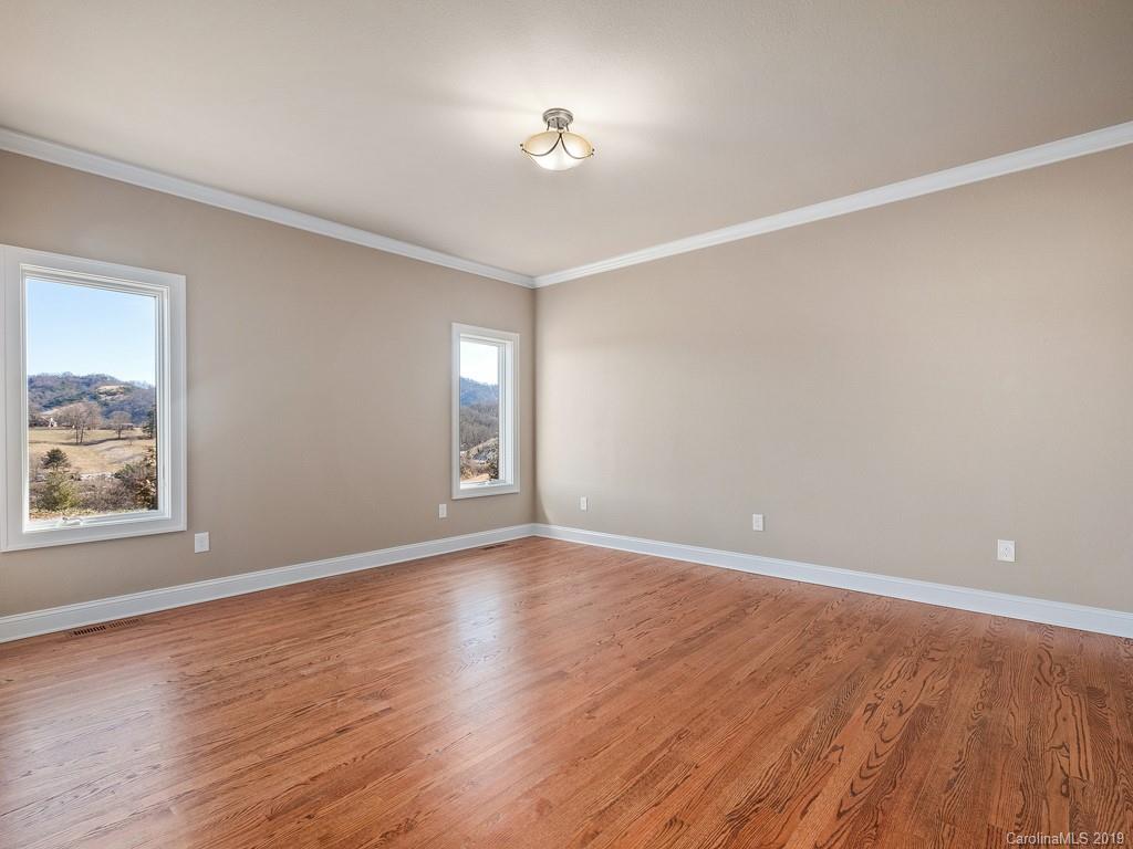 28 Jasper Ridge Clyde, NC 28721 - Photo 18 of 24 wooden floor in an empty room with a window