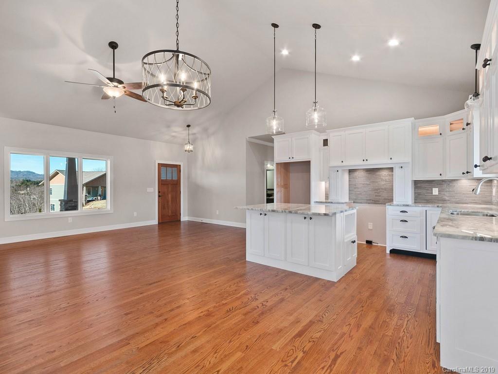 28 Jasper Ridge Clyde, NC 28721 - Photo 5 of 24 a large kitchen with stainless steel appliances granite countertop a large center island attached withe living room