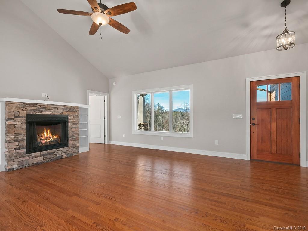 28 Jasper Ridge Clyde, NC 28721 - Photo 8 of 24 a view of an empty room with wooden floor fireplace and a window