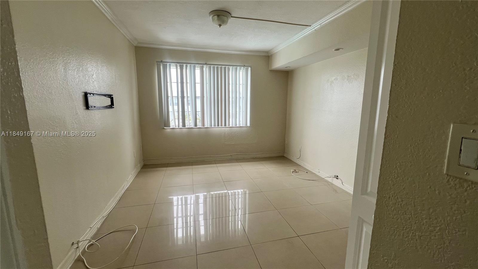 486 Northwest 165th Street, Unit B606 Miami, FL 33169 - Photo 11 of 19 a view of an empty room with a window