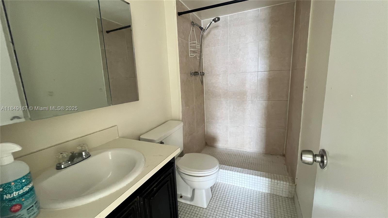 486 Northwest 165th Street, Unit B606 Miami, FL 33169 - Photo 13 of 19 a bathroom with a sink toilet and shower