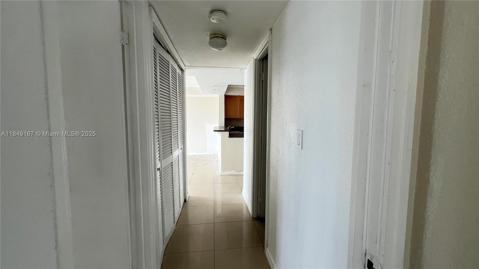 486 Northwest 165th Street, Unit B606 Miami, FL 33169 - Photo 18 of 19 a view of a bathroom from a hallway
