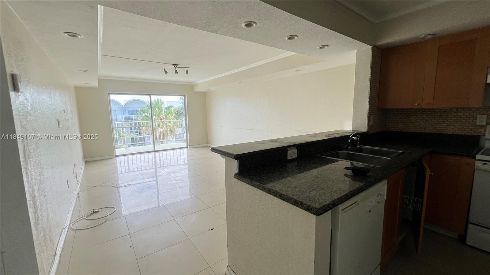 486 Northwest 165th Street, Unit B606 Miami, FL 33169 - Photo 3 of 19 a kitchen with a sink a stove and cabinets