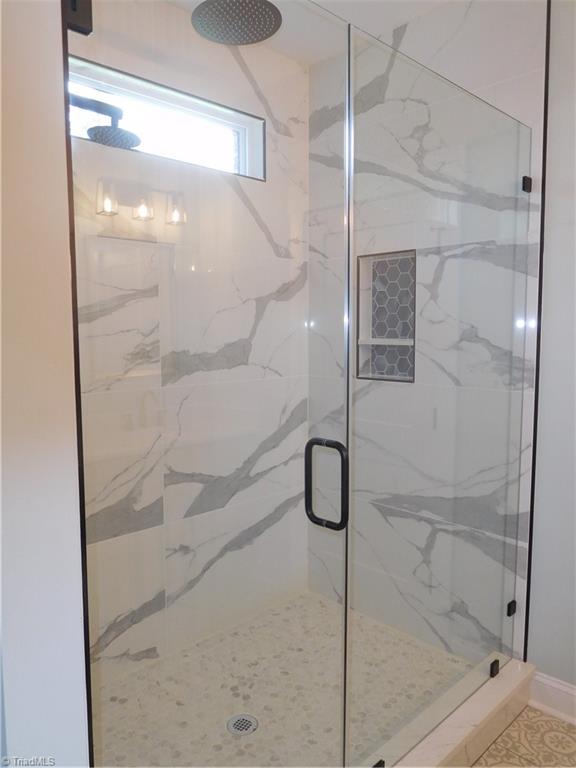 7805 Grapevine Road Lewisville, NC 27023 - Photo 28 of 45 PRIMARY BATHROOM. OVERSIZED WALK-IN RAIN SHOWER COMPLETE WITH SHOWER DOOR.
