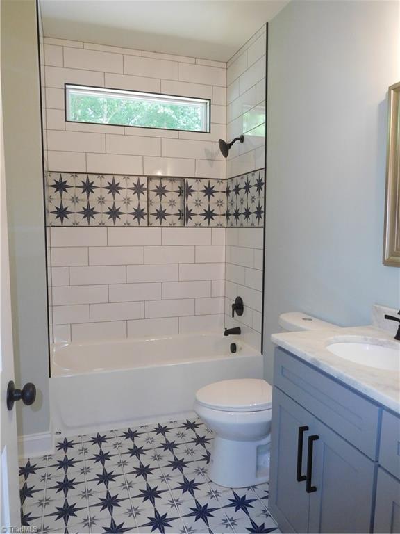 7805 Grapevine Road Lewisville, NC 27023 - Photo 32 of 45 2ND FLOOR HALL FULL BATH. CREATIVE TILE FOR THE FLOOR AND TUB/SHOWER, QUARTZ COUNTERS.