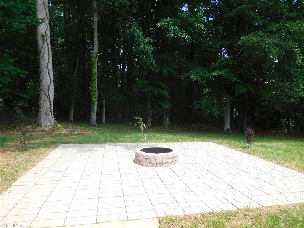 7805 Grapevine Road Lewisville, NC 27023 - Photo 37 of 45 FIREPIT ALREADY IN PLACE. THERE IS ALSO A GRILLING PAD NEXT TO THE PORCH.