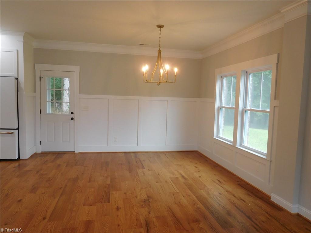7805 Grapevine Road Lewisville, NC 27023 - Photo 8 of 45 DINING ROOM. BRIGHT & AIRY. DOOR LEADS OUT TO FABULOUS SCREENED IN PORCH.
