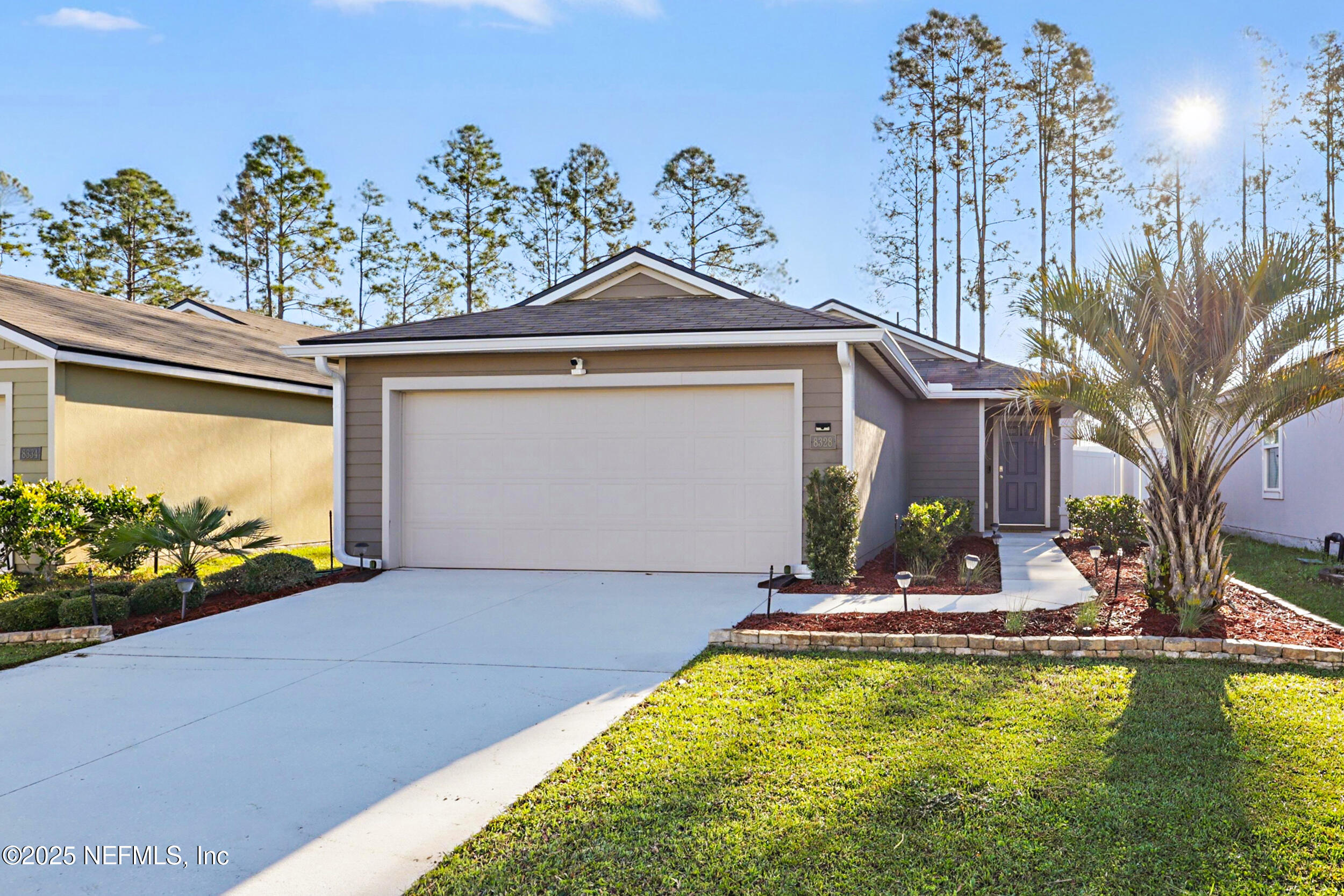 a front view of a house with a yard garage and a chair