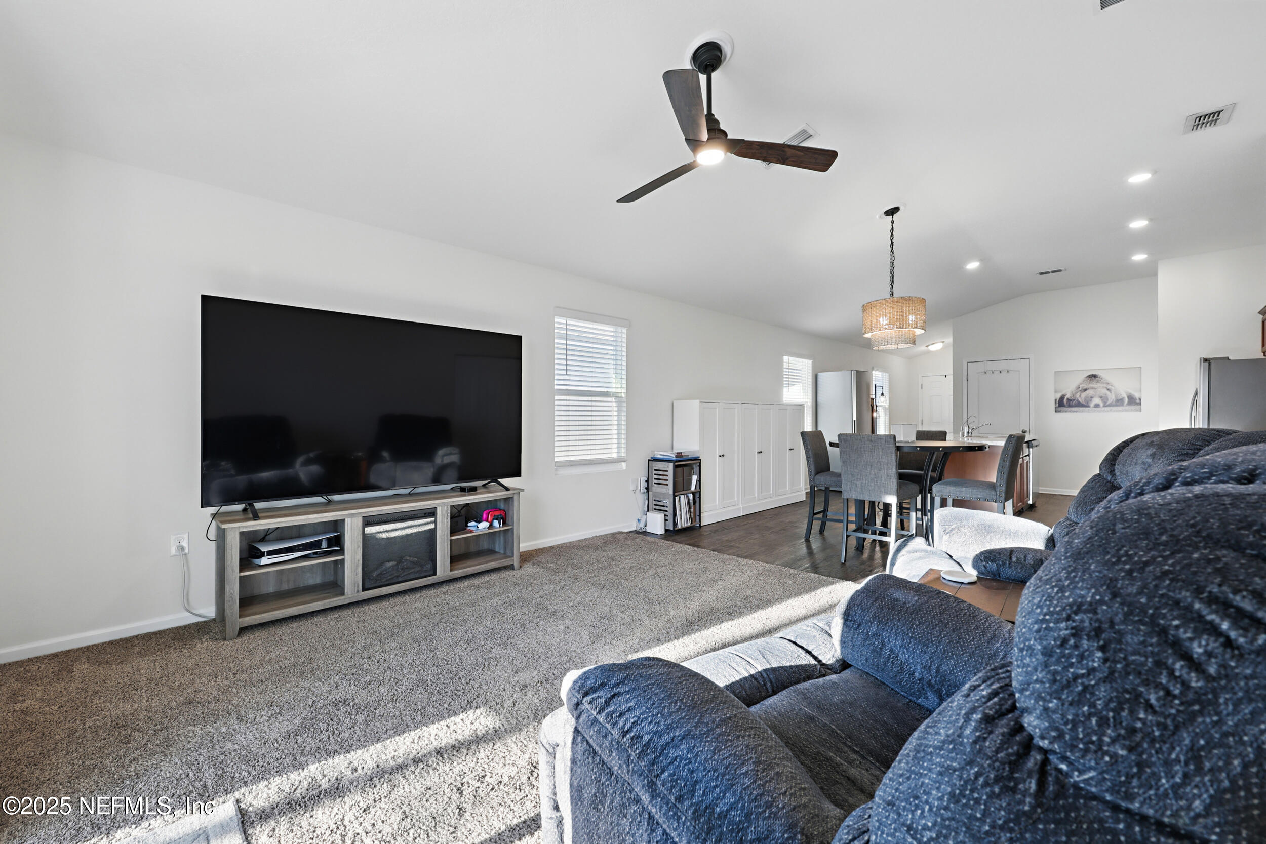 8328 Cape Fox Drive Jacksonville, FL 32222 - Photo 14 of 34 a living room with furniture and a flat screen tv