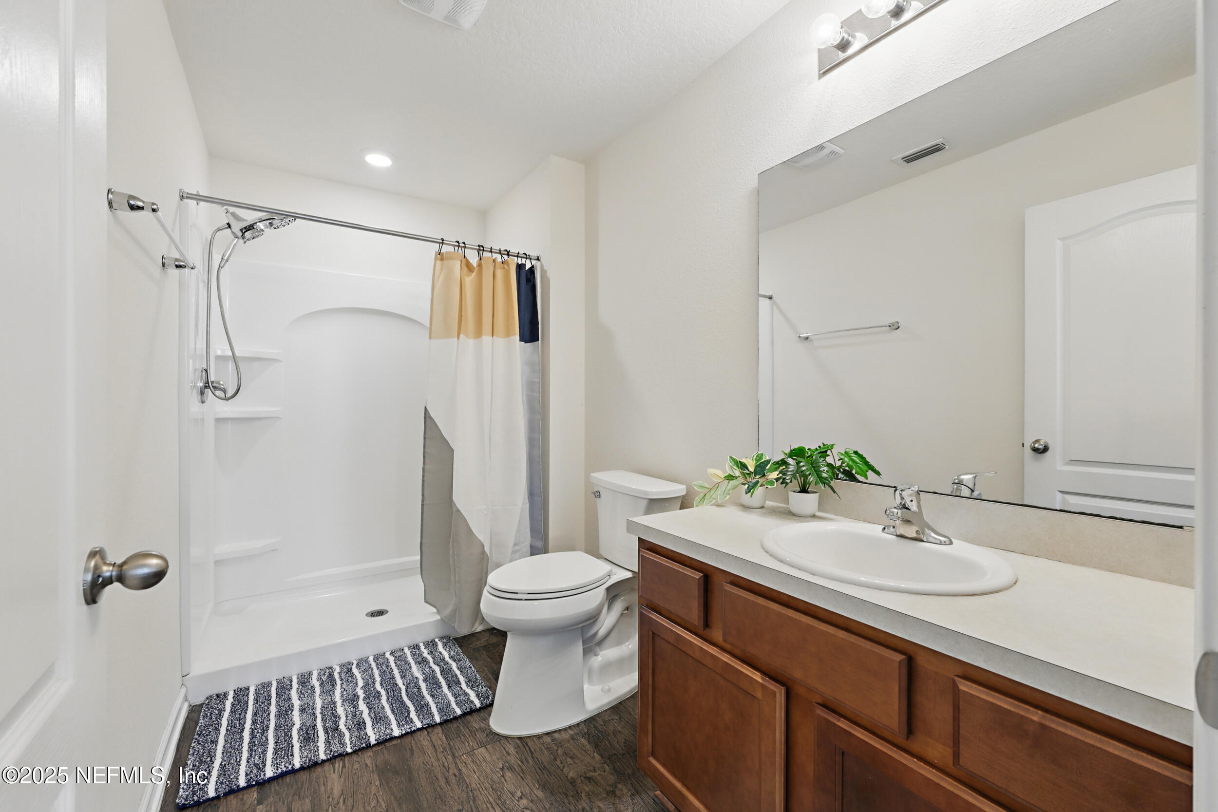 8328 Cape Fox Drive Jacksonville, FL 32222 - Photo 19 of 34 a bathroom with a sink toilet a mirror and shower