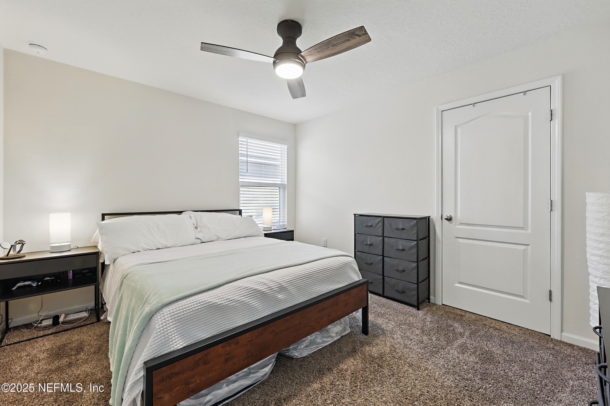 8328 Cape Fox Drive Jacksonville, FL 32222 - Photo 20 of 34 a bedroom with a bed and a chandelier