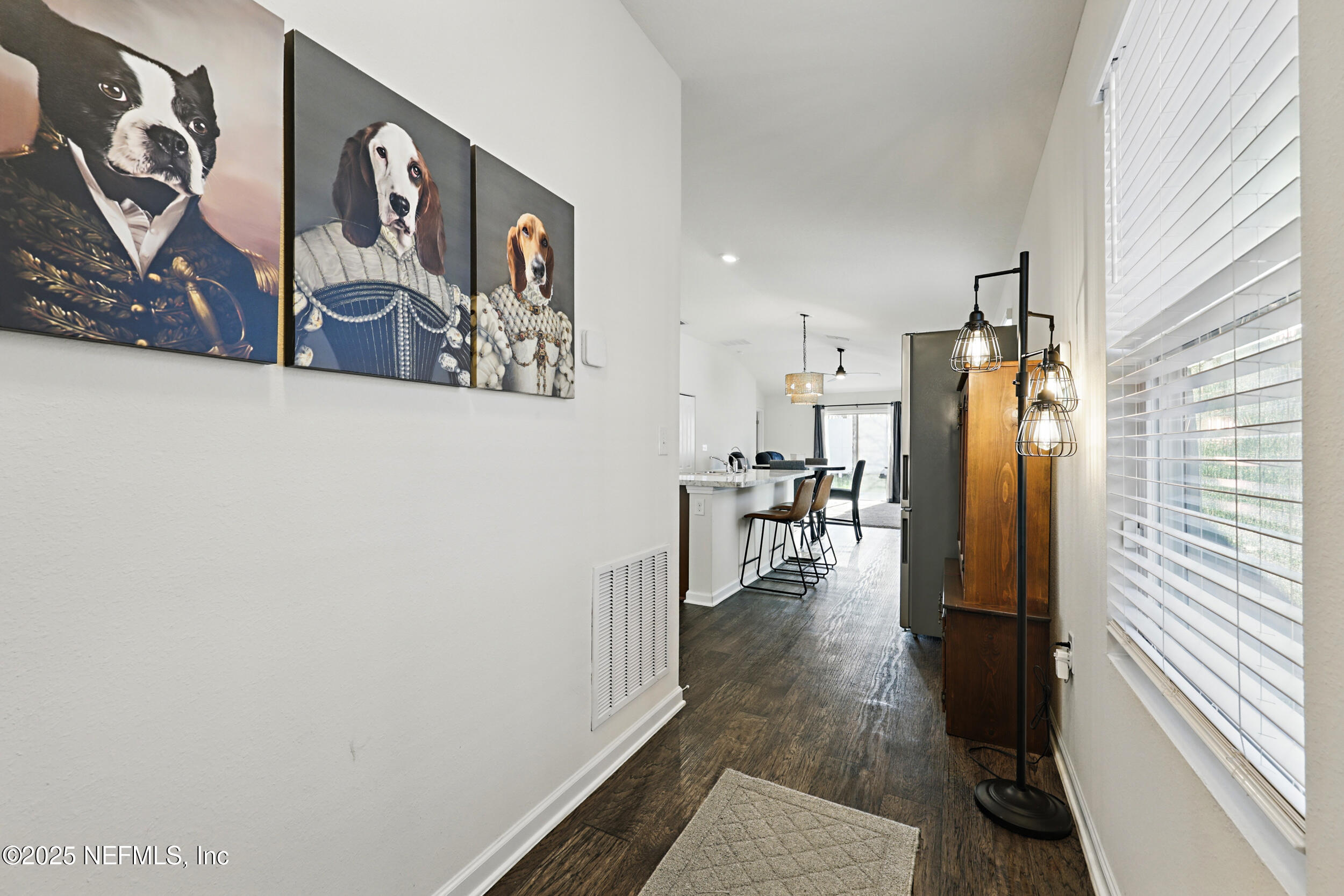 8328 Cape Fox Drive Jacksonville, FL 32222 - Photo 5 of 34 a view of a hallway with wooden floor