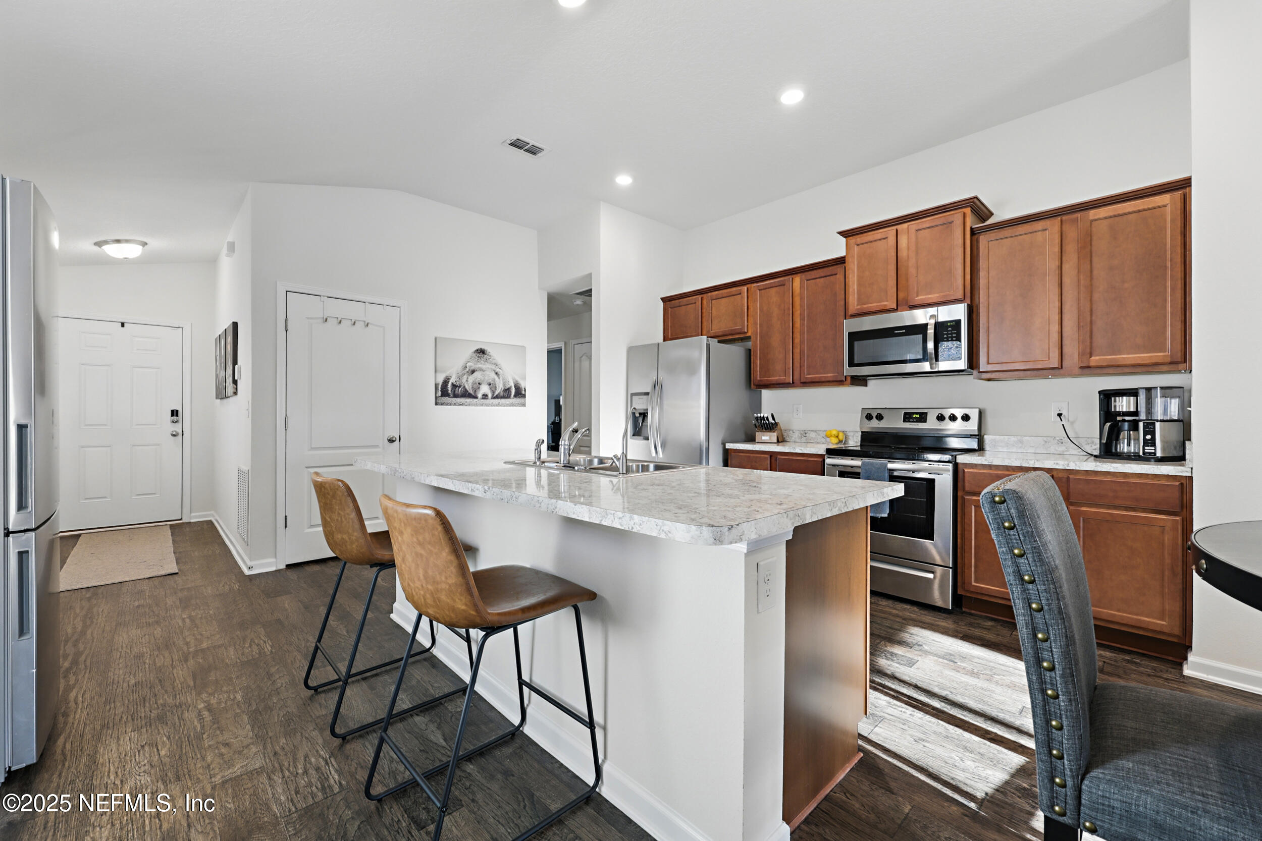 8328 Cape Fox Drive Jacksonville, FL 32222 - Photo 8 of 34 a kitchen with stainless steel appliances granite countertop a stove a sink a refrigerator and a refrigerator