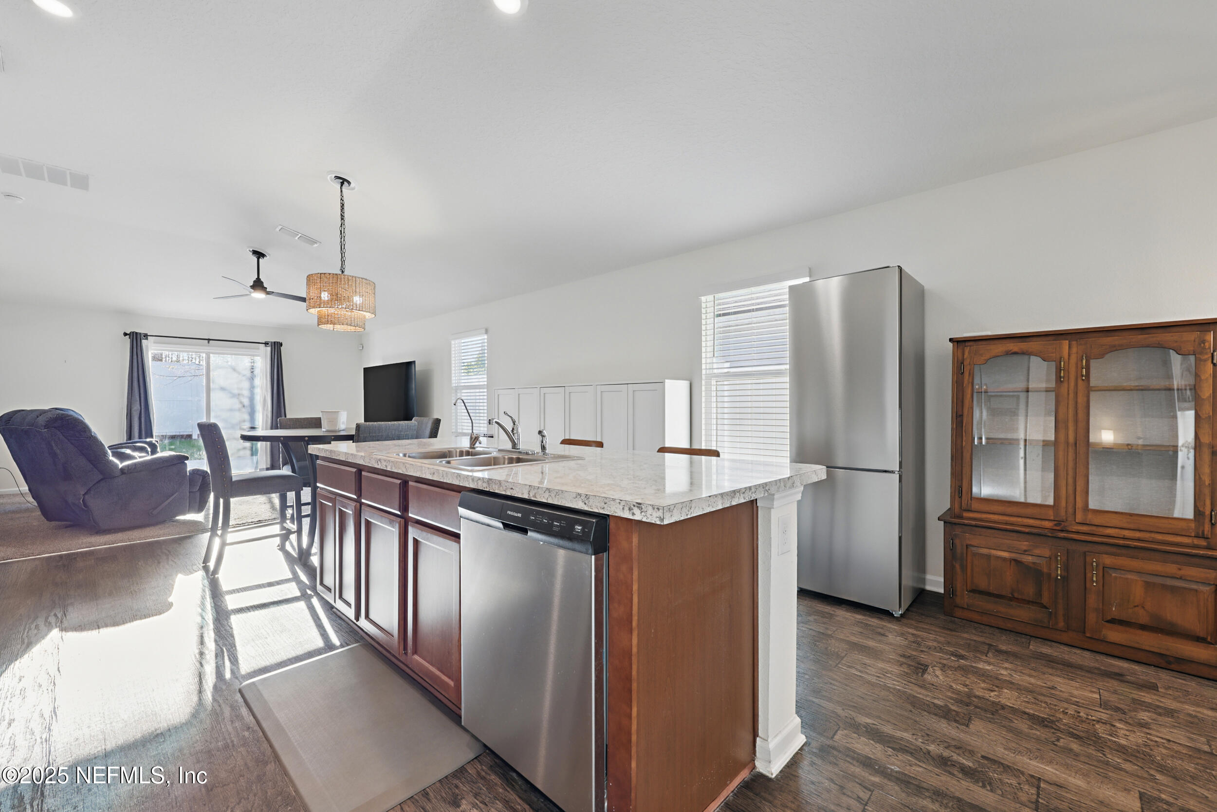 8328 Cape Fox Drive Jacksonville, FL 32222 - Photo 10 of 34 a kitchen with stainless steel appliances granite countertop a kitchen island hardwood floor and a sink