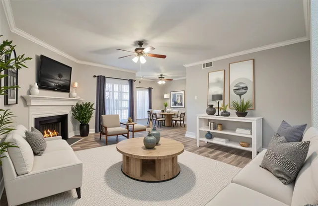 a living room with furniture a fireplace and a flat screen tv