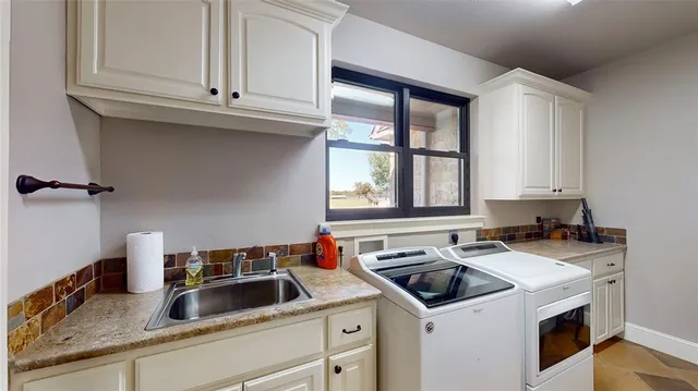 a kitchen with a sink cabinets and a stove
