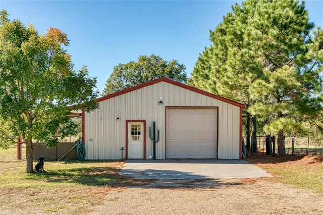 a view of tree in front of a house with large tree