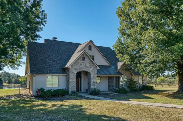 a kitchen with a table chairs refrigerator and microwave