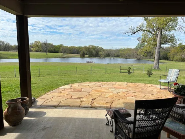 a view of a garden with a bench and trees