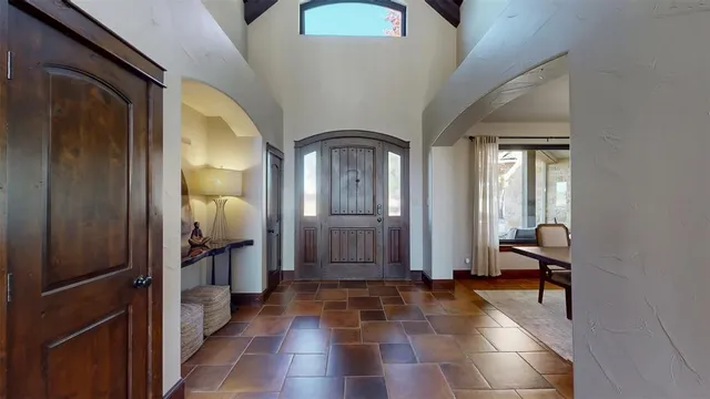 a view of a hallway with windows and closet