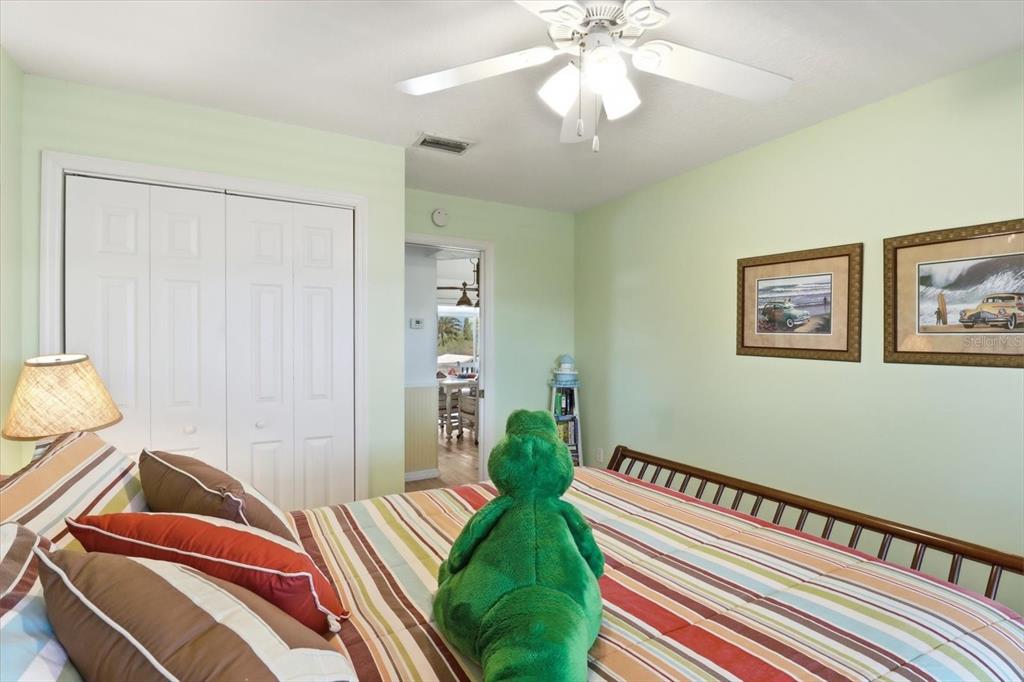 2882 North Comanche Point Crystal River, FL 34429 - Photo 12 of 39 a bedroom with bed and a chandelier