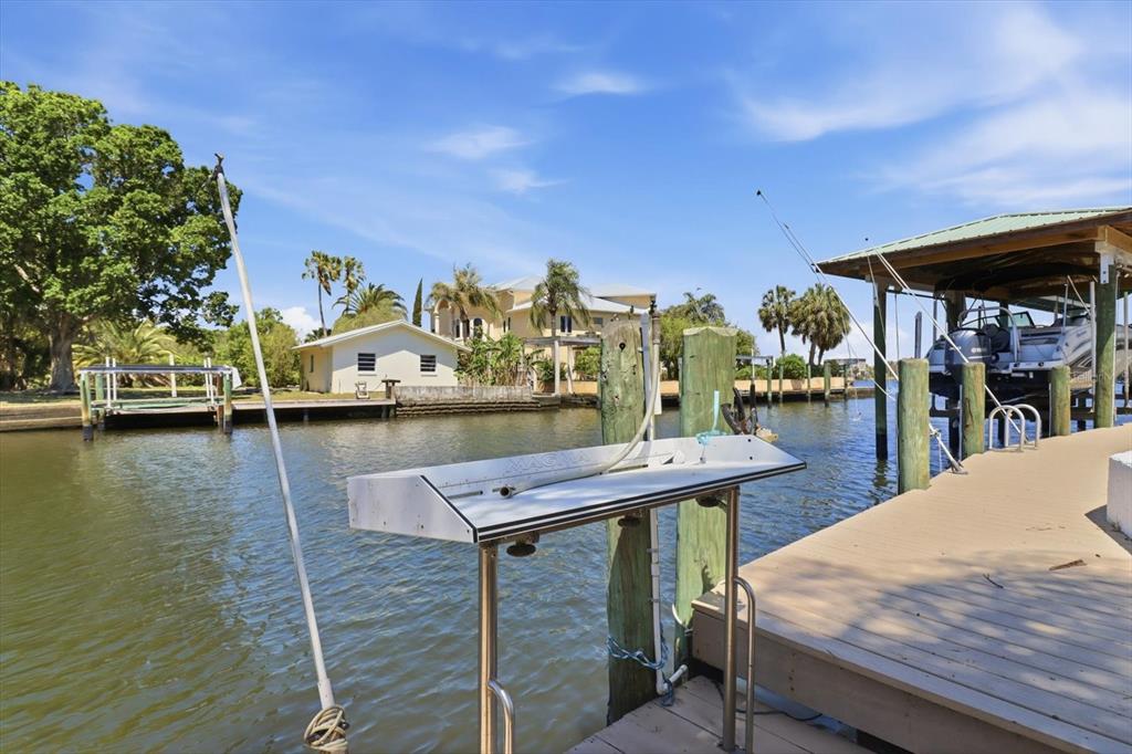 2882 North Comanche Point Crystal River, FL 34429 - Photo 27 of 39 a view of a outdoor kitchen with a table and chairs