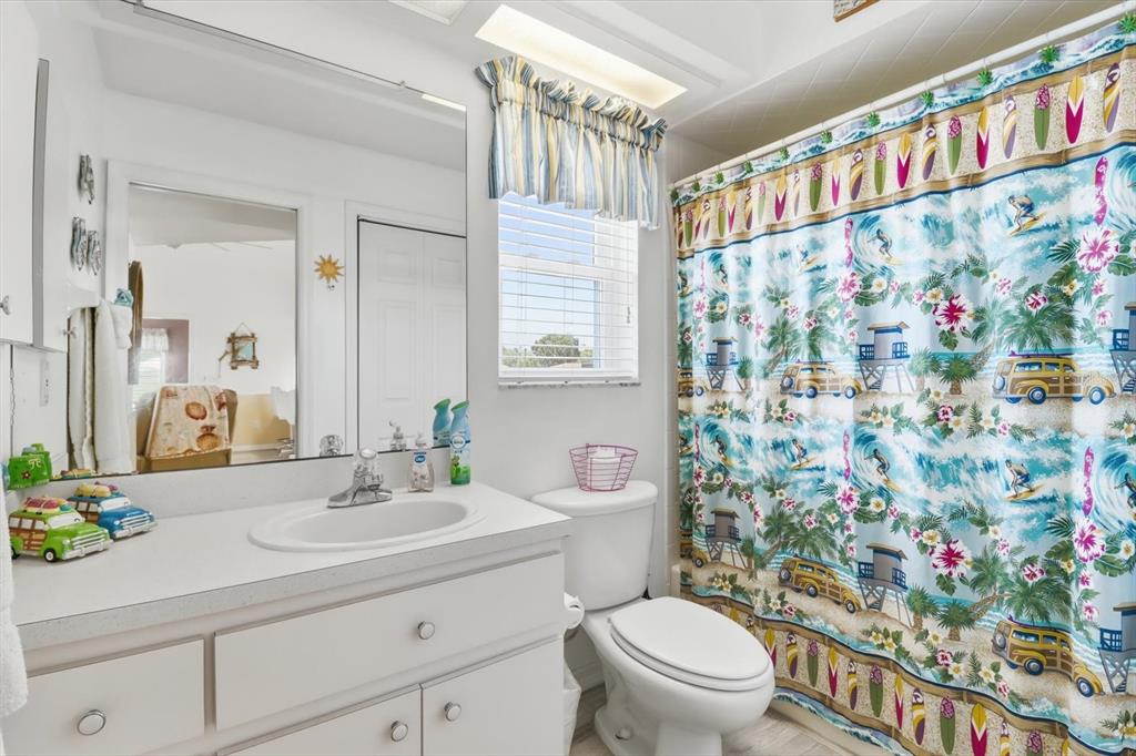 2882 North Comanche Point Crystal River, FL 34429 - Photo 10 of 39 a bathroom with a sink a toilet and a shower curtain