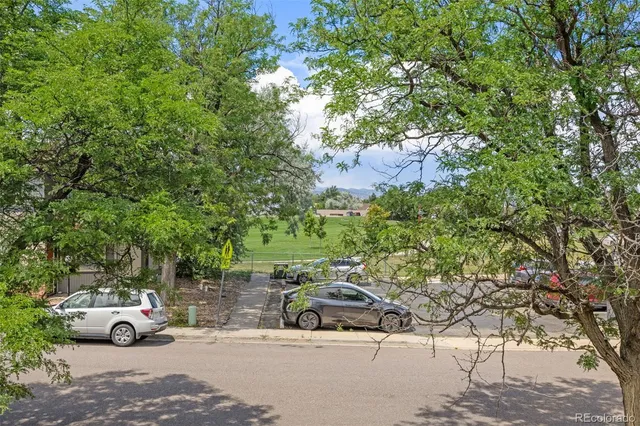 a view of street with parked cars