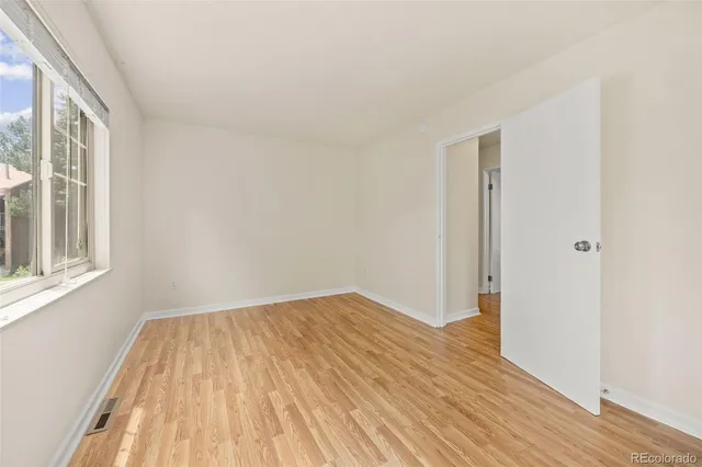 a view of room with window and wooden floor