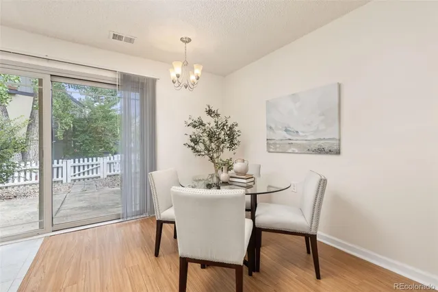 a dining room with furniture wooden floor and a chandelier