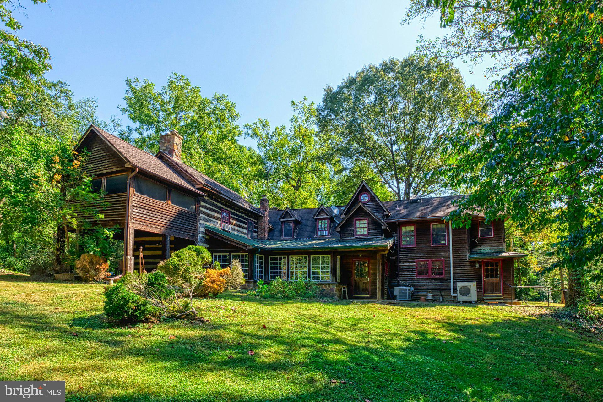a yellow house in middle of the green field