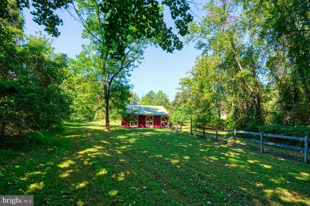 an aerial view of a house with a yard and lake view