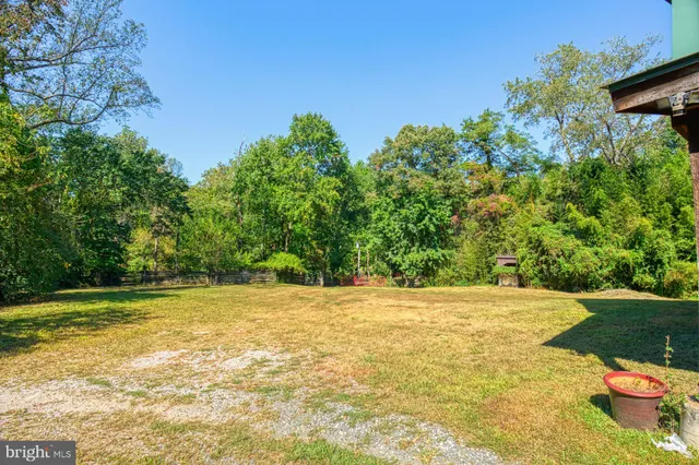 a swimming pool with outdoor seating and yard