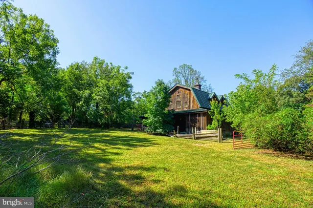 a backyard of a house with large trees