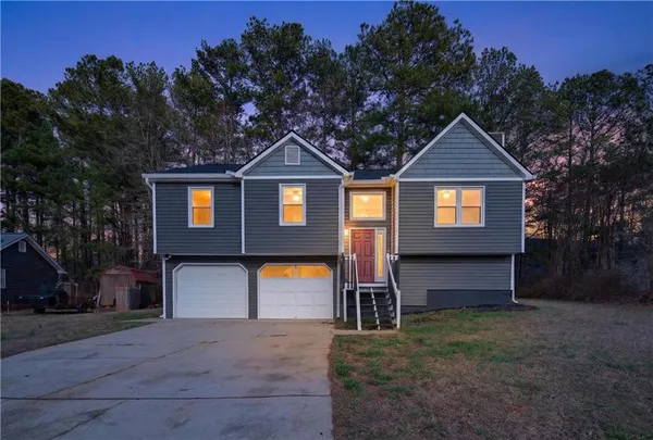 a front view of a house with a yard and garage