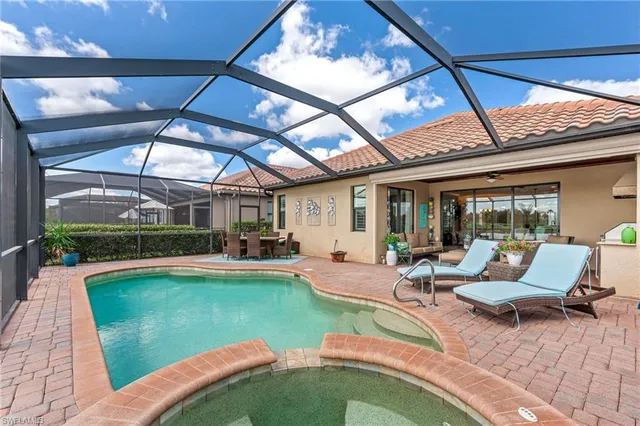 a view of a patio with table and chairs potted plants with wooden floor and fence