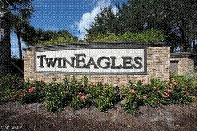 a sign broad in front of flowers