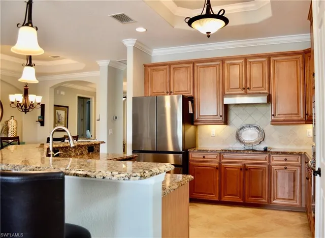 a kitchen with refrigerator and cabinets
