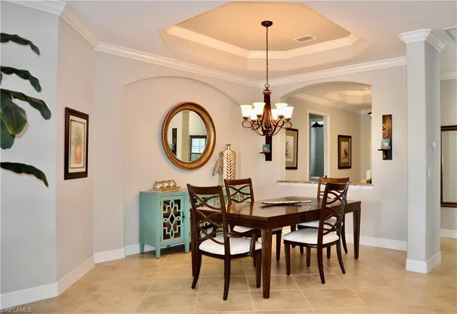 a dining room with furniture and a chandelier