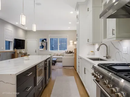 a large kitchen with a stove and a sink