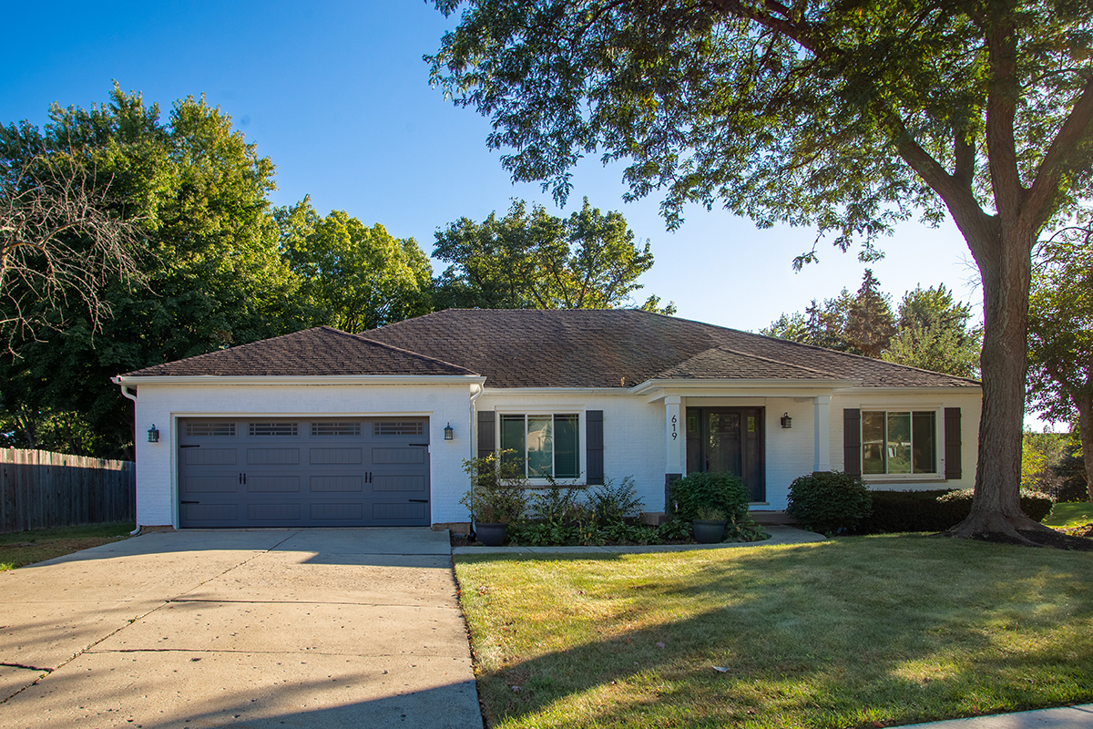 619 West End Road Roselle, IL 60172 - Photo 1 of 37 a front view of a house with a garden and tree